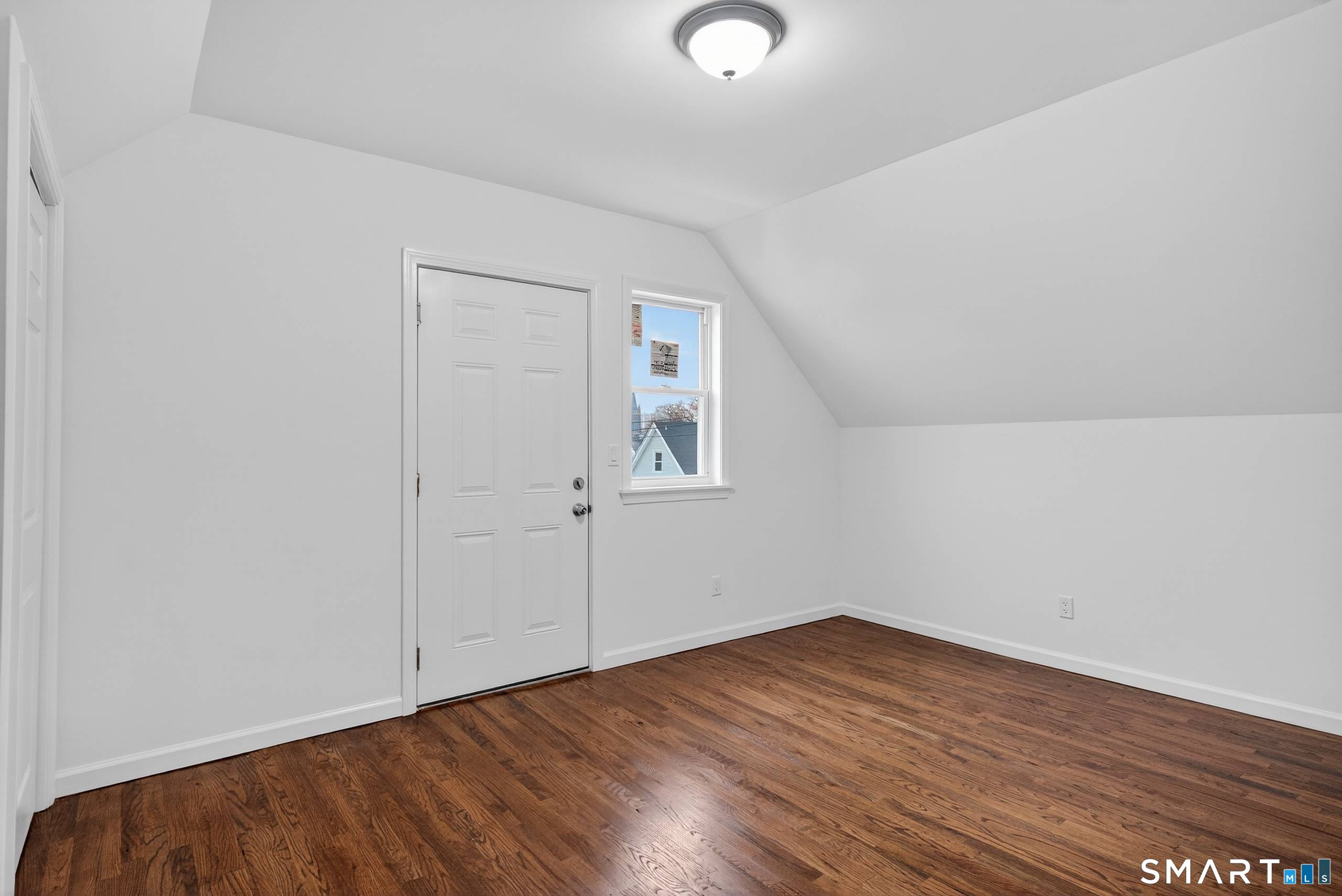 144 Cottage Street, Unit 3 Bridgeport, CT 06605 - Photo 12 of 12 a view of an empty room with wooden floor