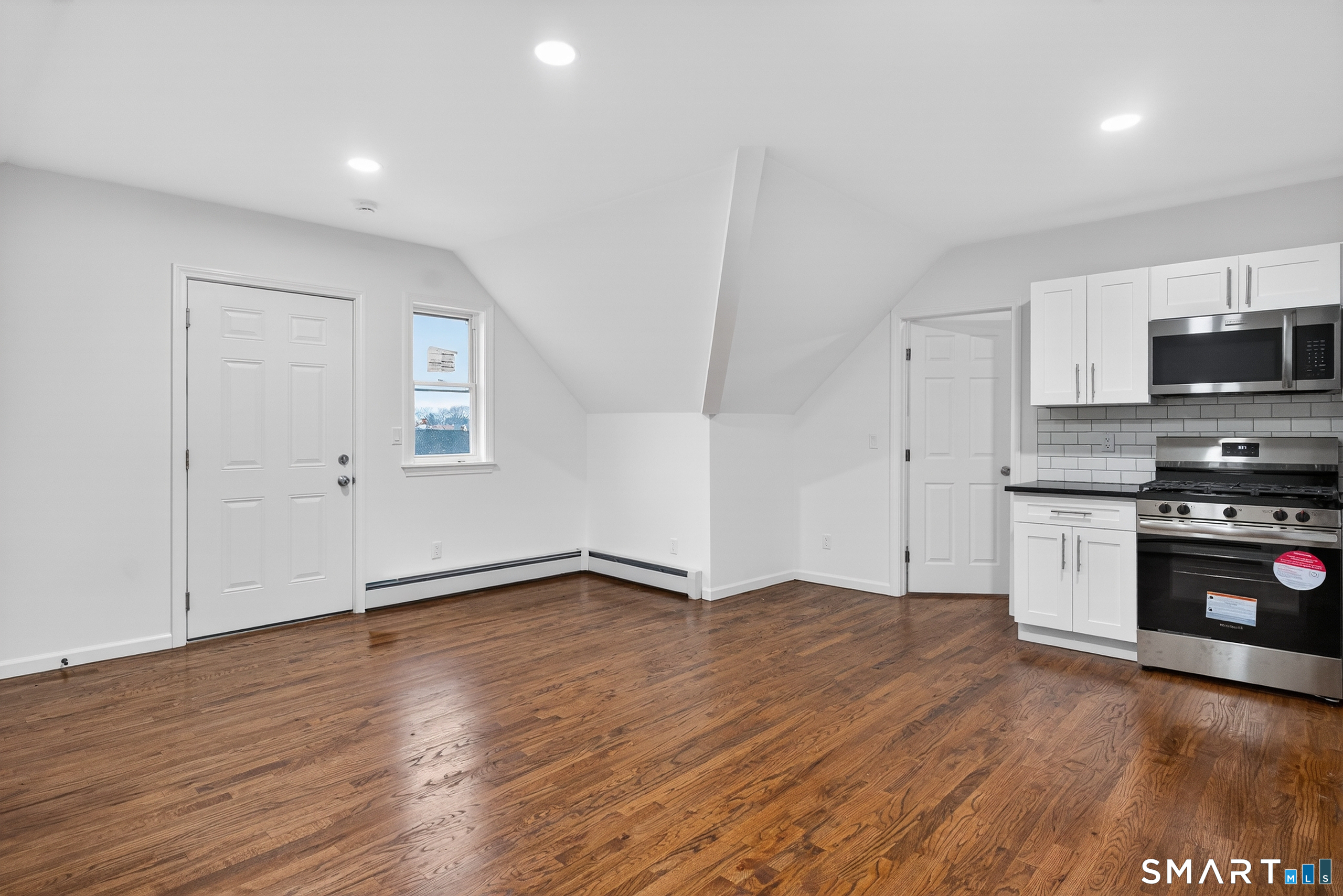 144 Cottage Street, Unit 3 Bridgeport, CT 06605 - Photo 6 of 12 a view of a kitchen with a sink and a stove top oven