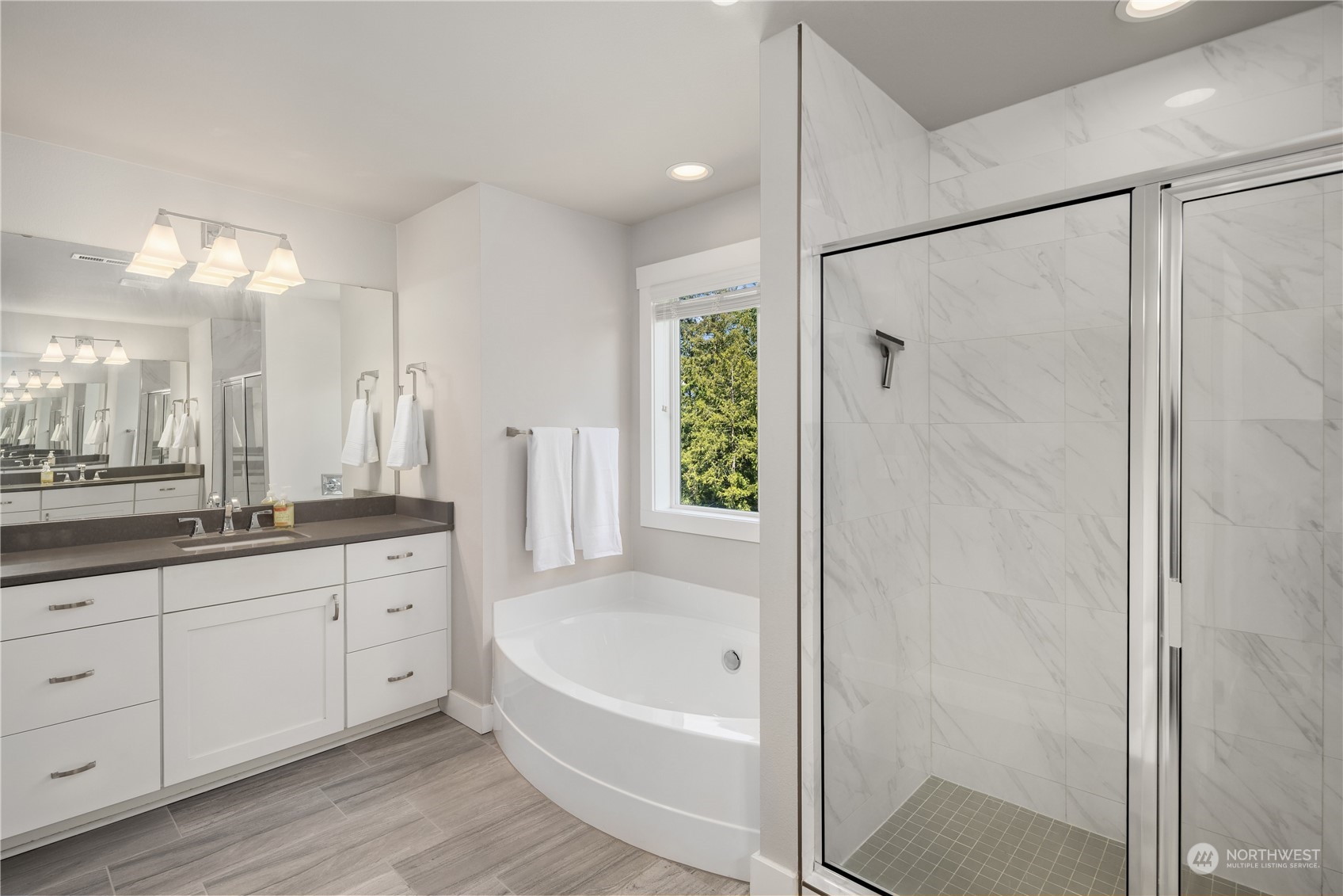 18105 3rd Drive Southeast Bothell, WA 98012 - Photo 15 of 28 a bathroom with a granite countertop sink a mirror a bathtub and shower