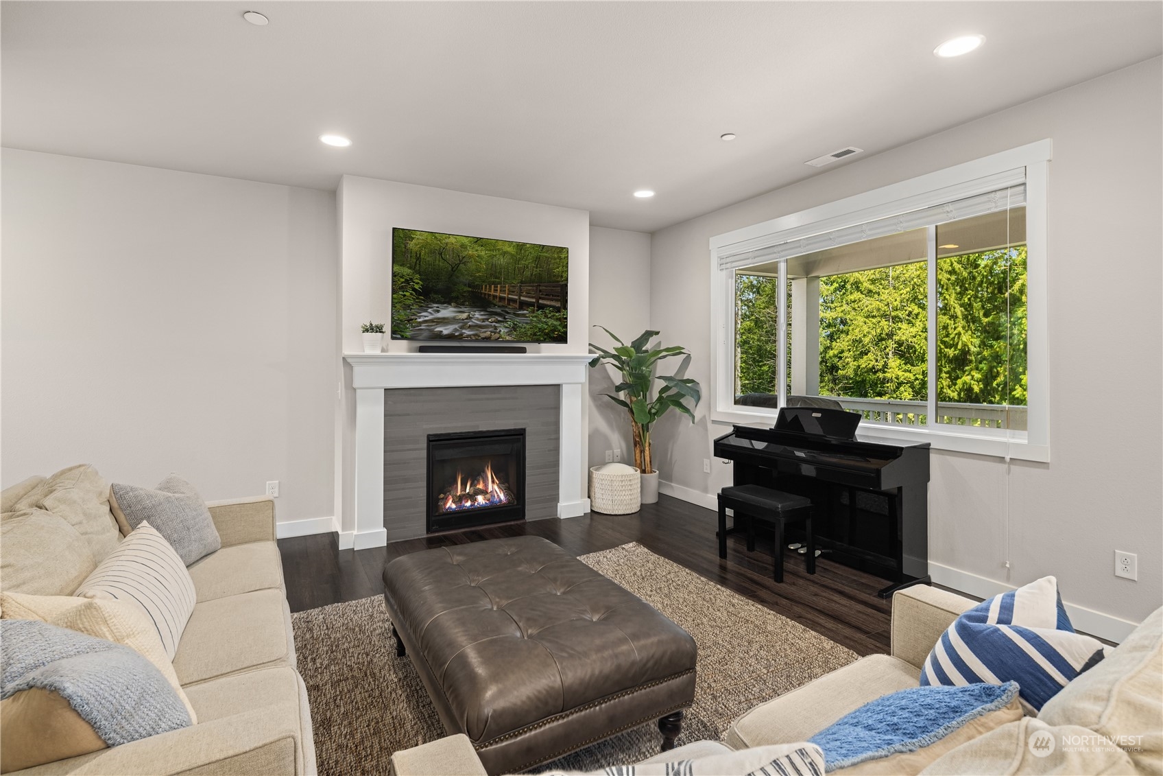 18105 3rd Drive Southeast Bothell, WA 98012 - Photo 4 of 28 a living room with furniture a flat screen tv and a fireplace