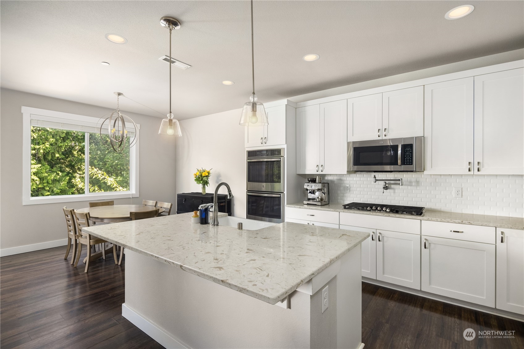 18105 3rd Drive Southeast Bothell, WA 98012 - Photo 8 of 28 a kitchen with stainless steel appliances granite countertop a stove a sink a microwave a dining table and chairs