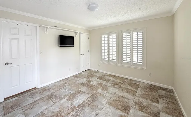 a view of a livingroom with an empty space and a window