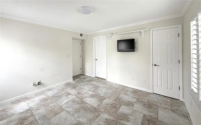 a view of walk in closet with empty racks