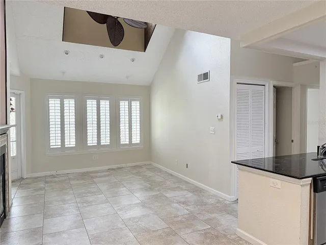 a kitchen with granite countertop a refrigerator stove and microwave