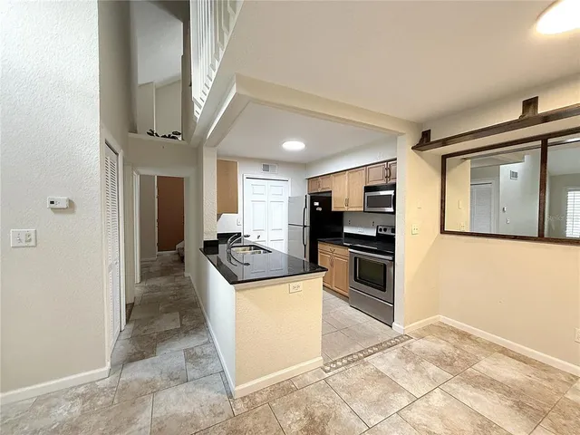 a view of a kitchen with a sink and a microwave