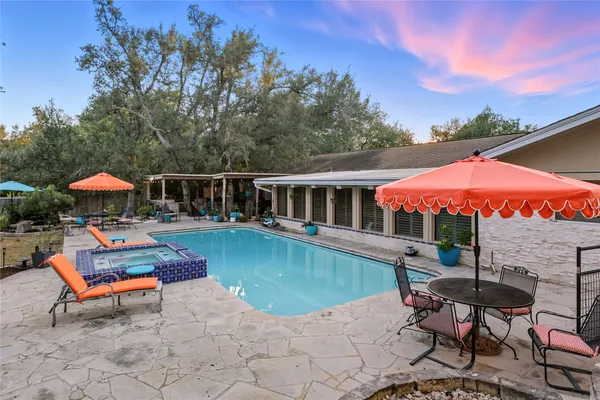 an outdoor space with pool and furniture