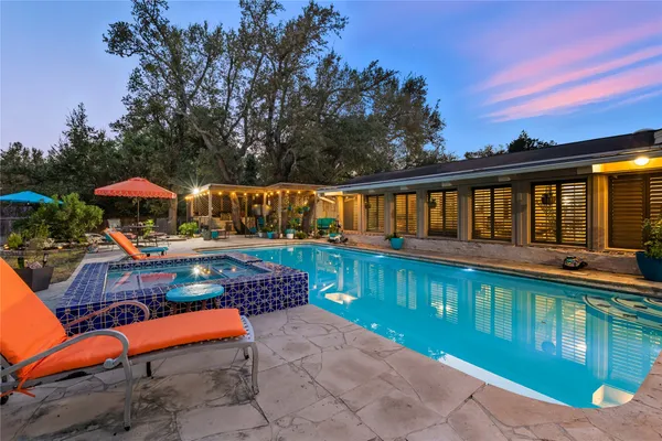 a view of swimming pool with sitting area