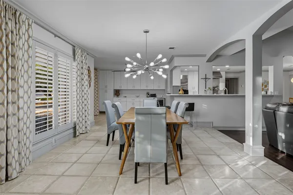 a view of a dining room with furniture and chandelier