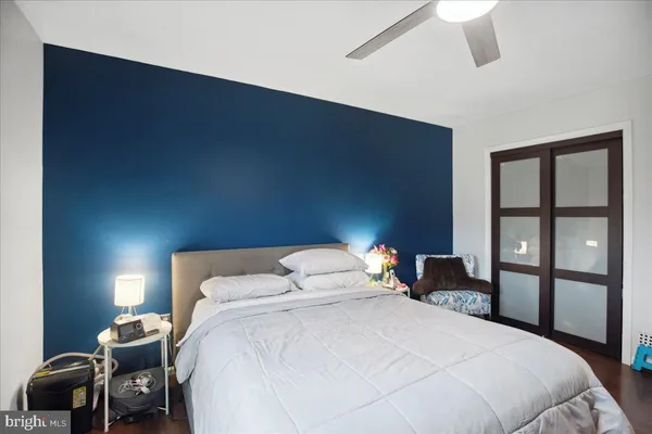a bedroom with a bed and wooden floor