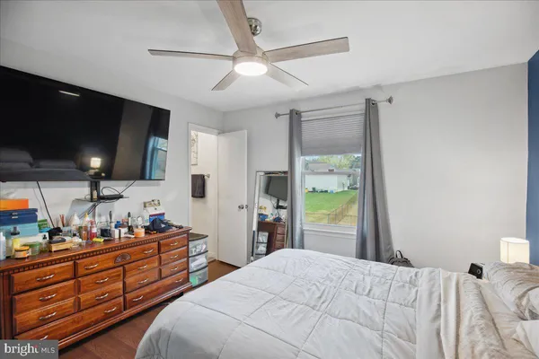 a bedroom with bed and flat tv screen on dresser