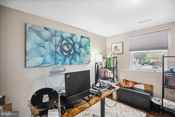 a living room with furniture a rug and a window