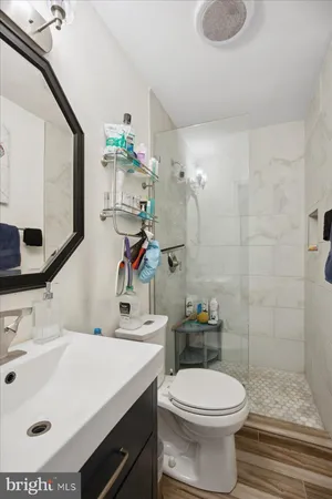 a bathroom with a sink a toilet and shower