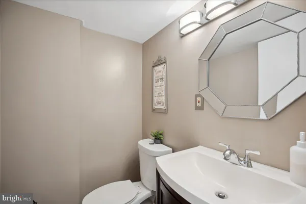 a bathroom with a sink mirror and toilet