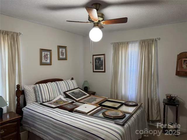 a view of a room with furniture and ceiling fan