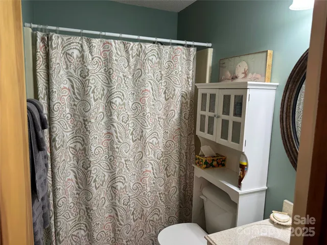 a white toilet sitting next to a bathroom sink
