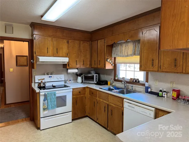 a kitchen with a stove sink and cabinets