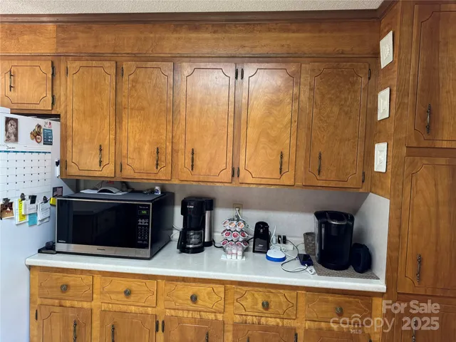 a kitchen with stainless steel appliances granite countertop a sink and cabinets