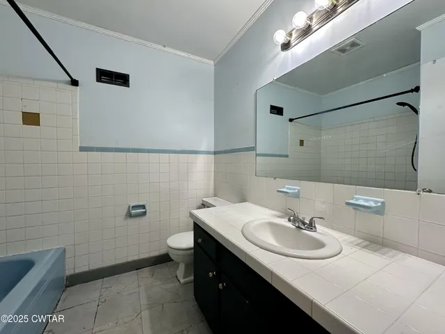 a bathroom with a sink toilet and mirror