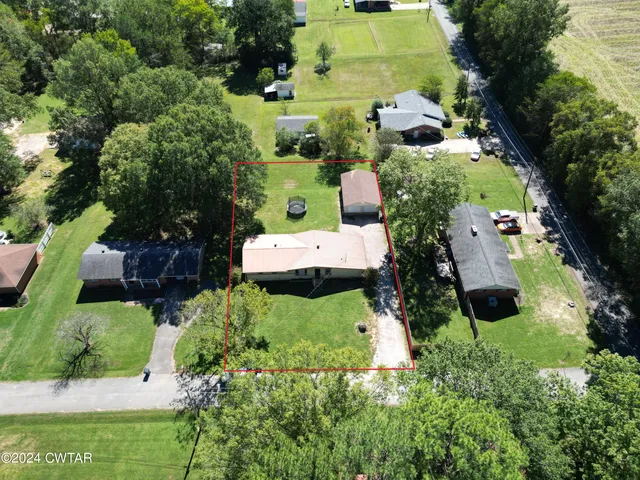 an aerial view of a house with outdoor space