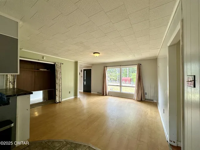 a view of empty room with wooden floor and cabinet