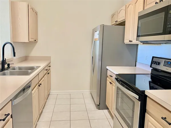 a kitchen with stainless steel appliances a stove microwave and refrigerator