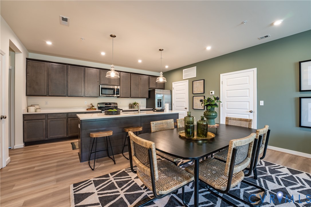3727 Maze Runner Drive Midlothian, VA 23112 - Photo 10 of 42 a kitchen with a dining table chairs and refrigerator