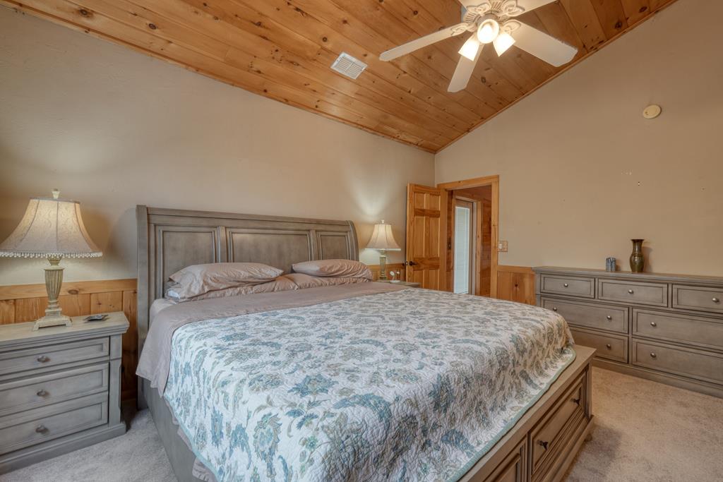 71 Andy Court Morganton, GA 30560 - Photo 14 of 43 a bedroom with a bed and a chandelier