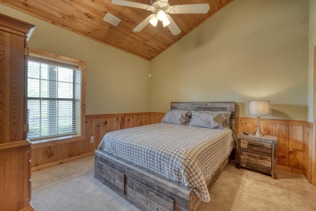 71 Andy Court Morganton, GA 30560 - Photo 20 of 43 a bedroom with a bed and a chandelier