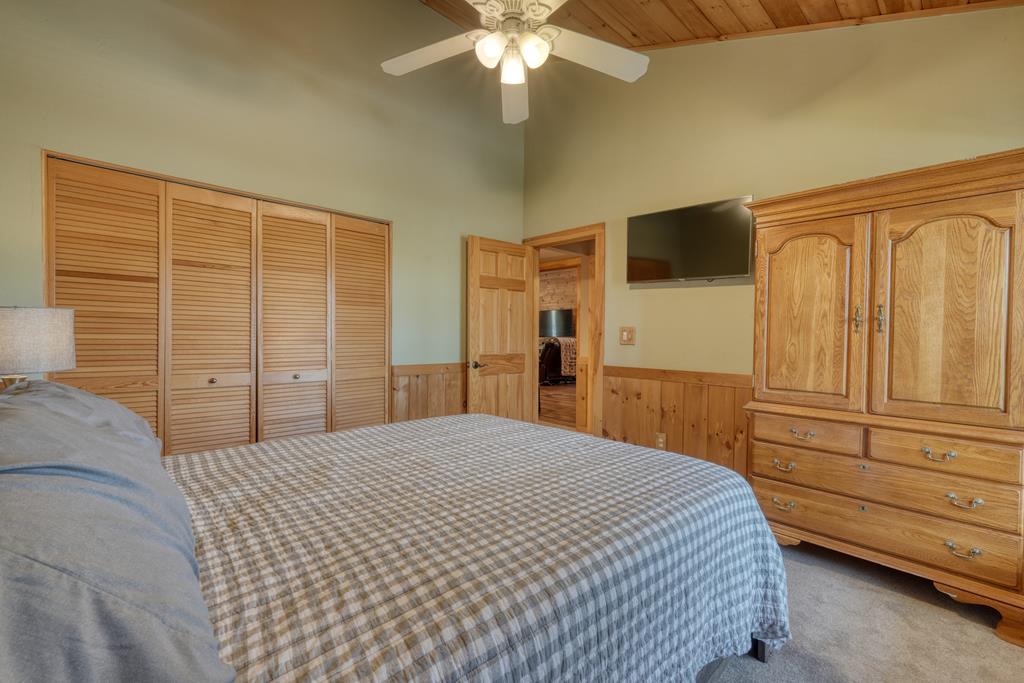 71 Andy Court Morganton, GA 30560 - Photo 21 of 43 a bedroom with a bed and a chandelier