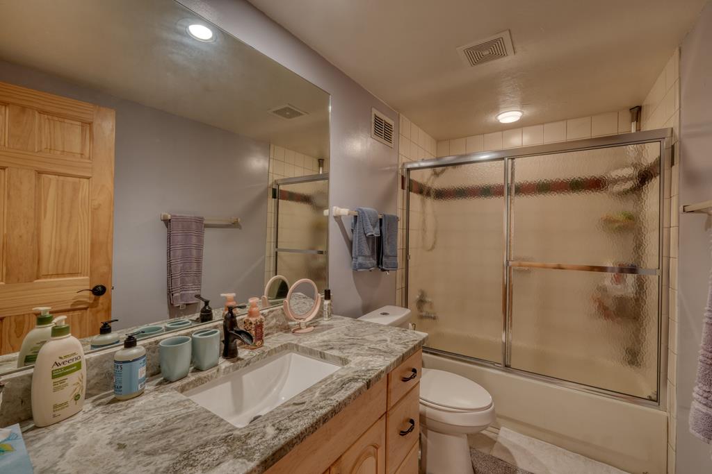 71 Andy Court Morganton, GA 30560 - Photo 22 of 43 a bathroom with a granite countertop sink toilet and shower