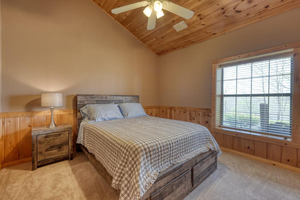 71 Andy Court Morganton, GA 30560 - Photo 23 of 43 a bedroom with a bed and a chandelier