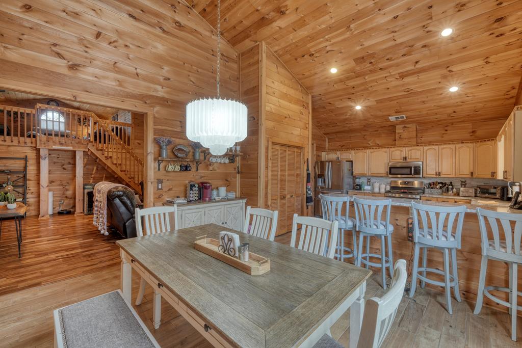 71 Andy Court Morganton, GA 30560 - Photo 7 of 43 a view of a dining room and livingroom with furniture wooden floor a chandelier