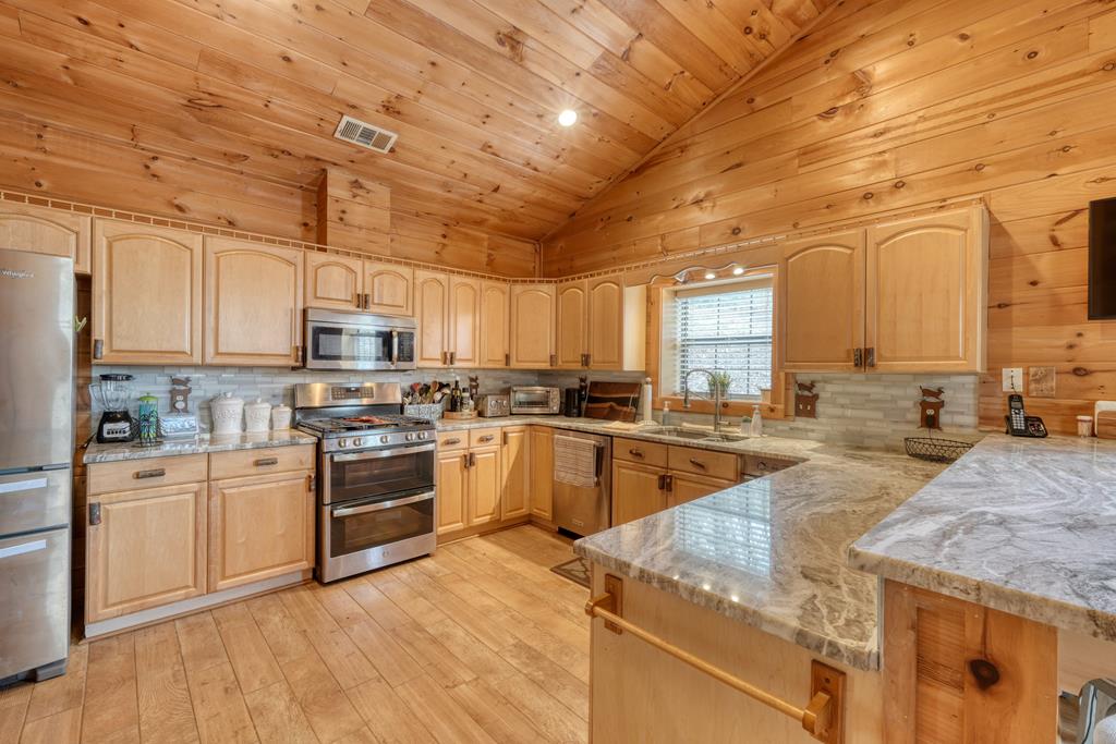 71 Andy Court Morganton, GA 30560 - Photo 8 of 43 a kitchen with stainless steel appliances granite countertop a stove sink and cabinets