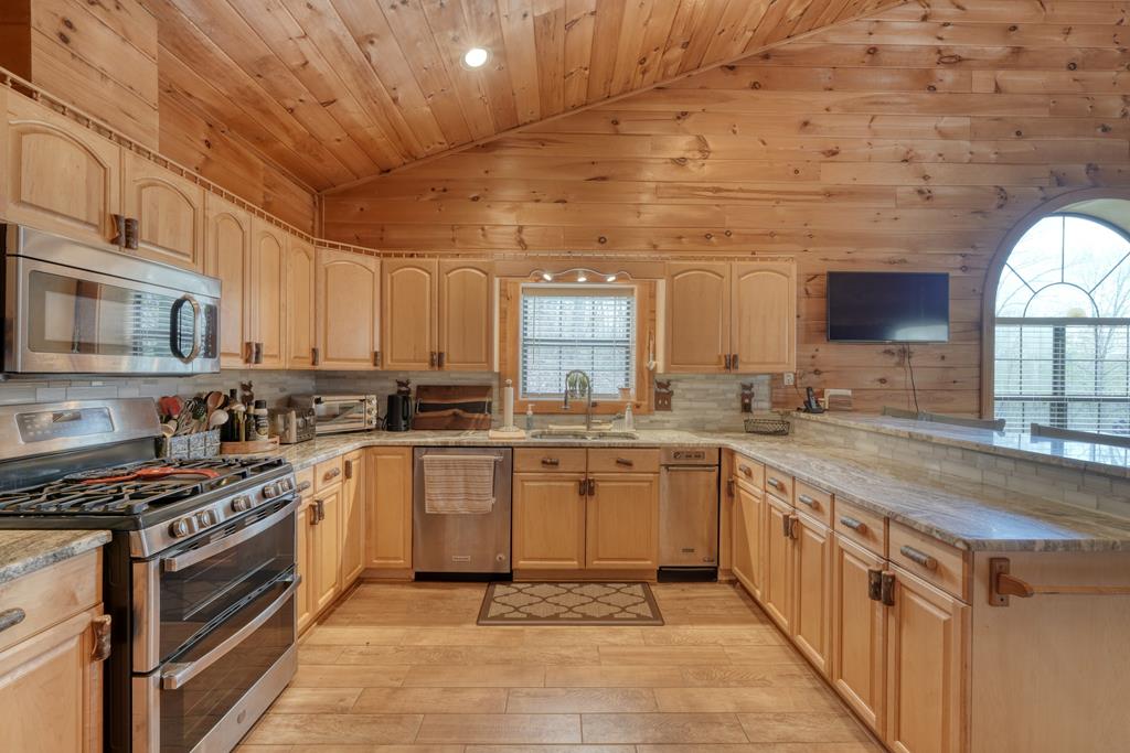 71 Andy Court Morganton, GA 30560 - Photo 9 of 43 a kitchen with stainless steel appliances granite countertop a stove a sink and a microwave