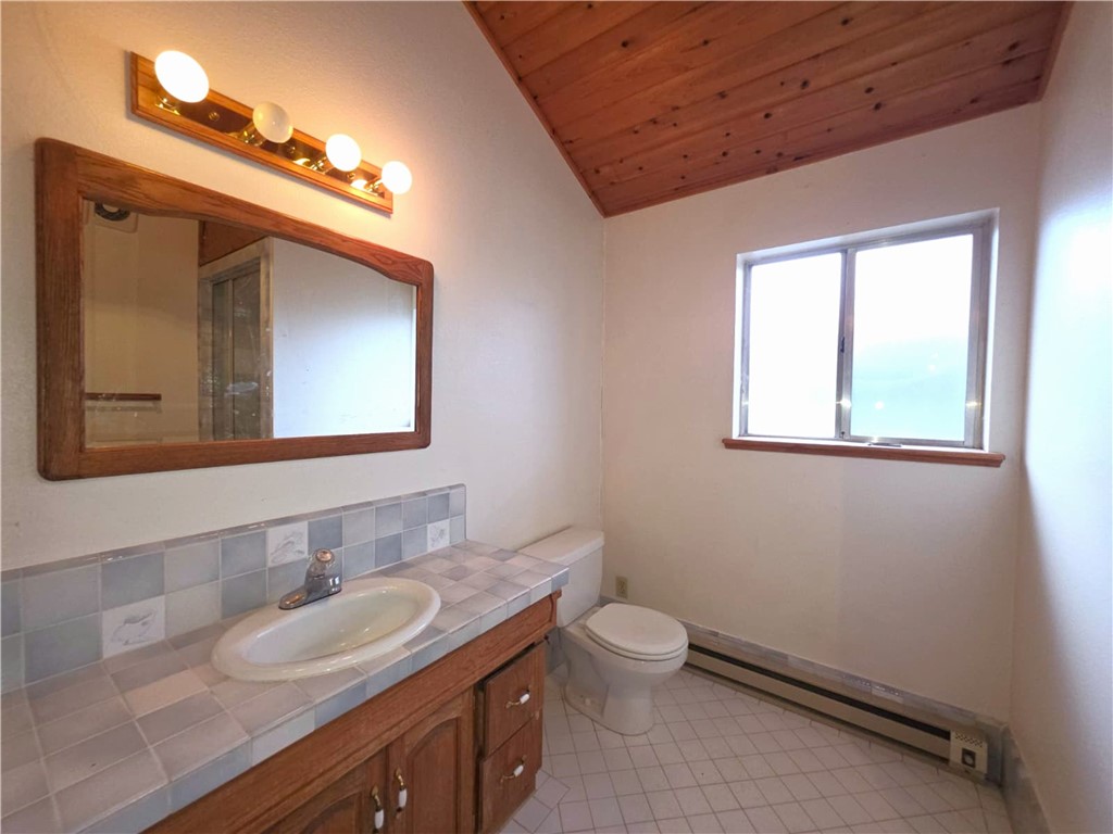 614 Lane Yreka, CA 96097 - Photo 22 of 39 a bathroom with a granite countertop sink vanity mirror and toilet