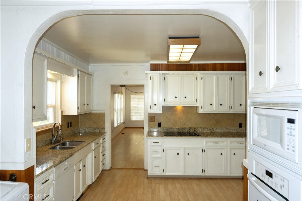 614 Lane Yreka, CA 96097 - Photo 10 of 39 a kitchen with granite countertop white cabinets and white appliances
