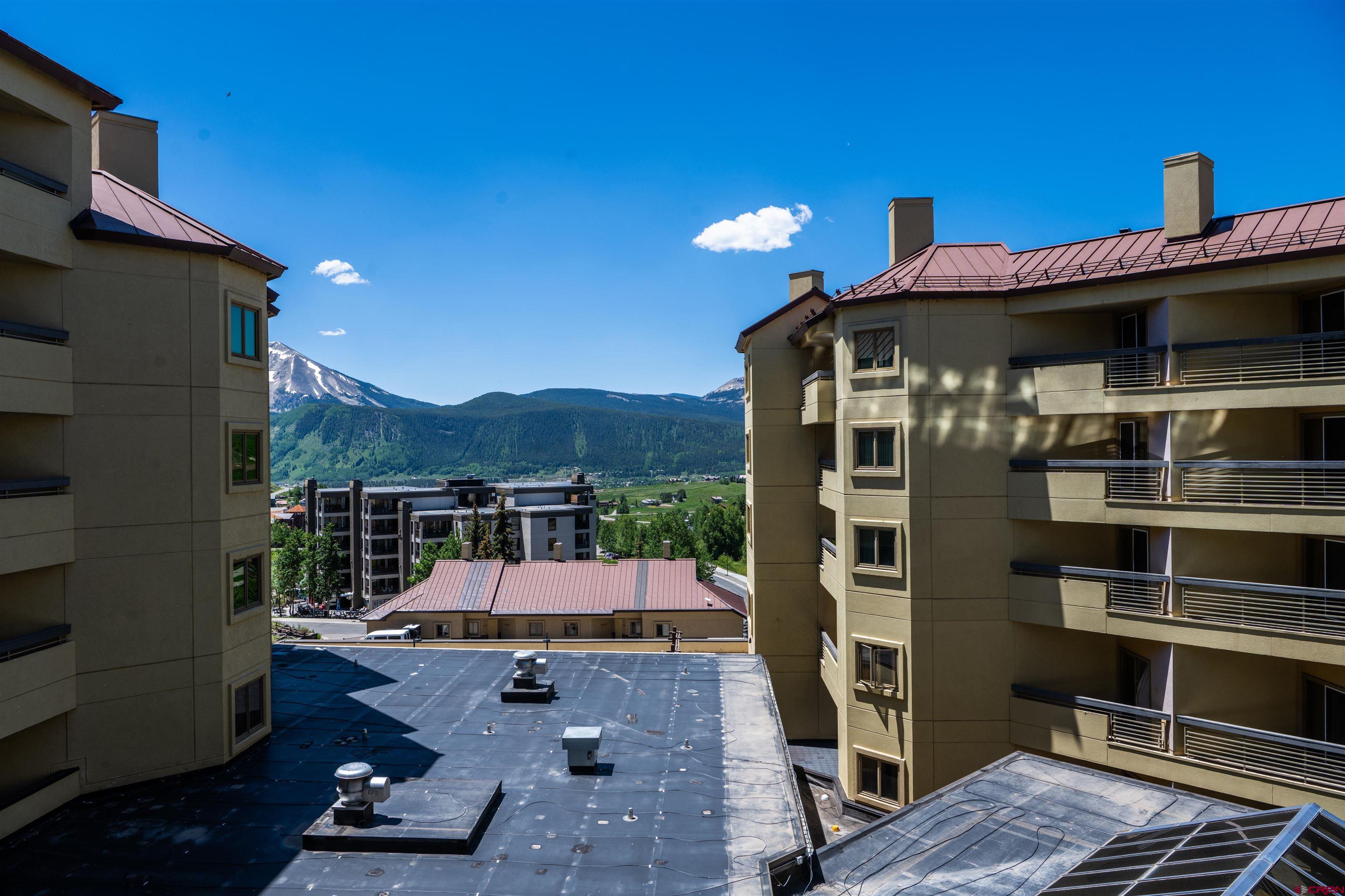 500 Gothic Road, Unit 431 Crested Butte, CO 81225 - Photo 16 of 19 a view of a patio with table and chairs with wooden floor and fence
