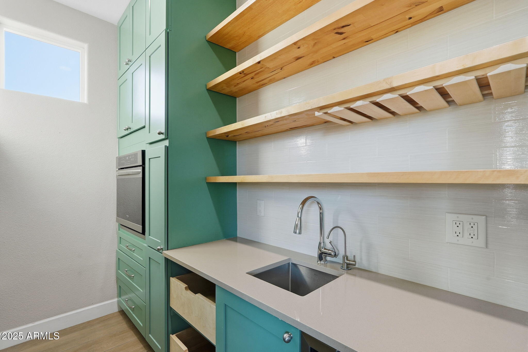 245 West Sagebrush Street Gilbert, AZ 85233 - Photo 15 of 62 a kitchen with a sink a refrigerator and cabinets
