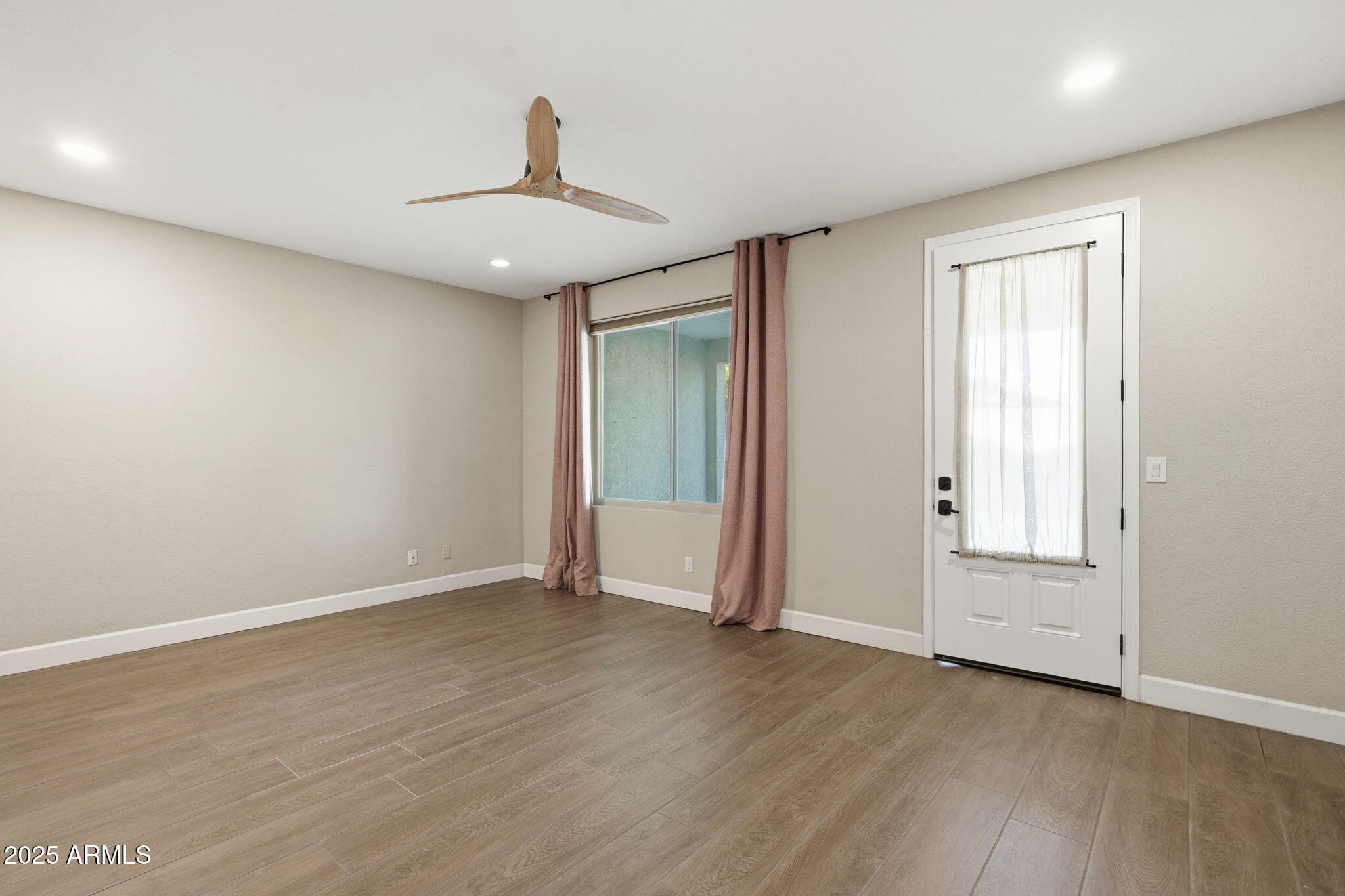 245 West Sagebrush Street Gilbert, AZ 85233 - Photo 22 of 62 an empty room with wooden floor cabinet and windows