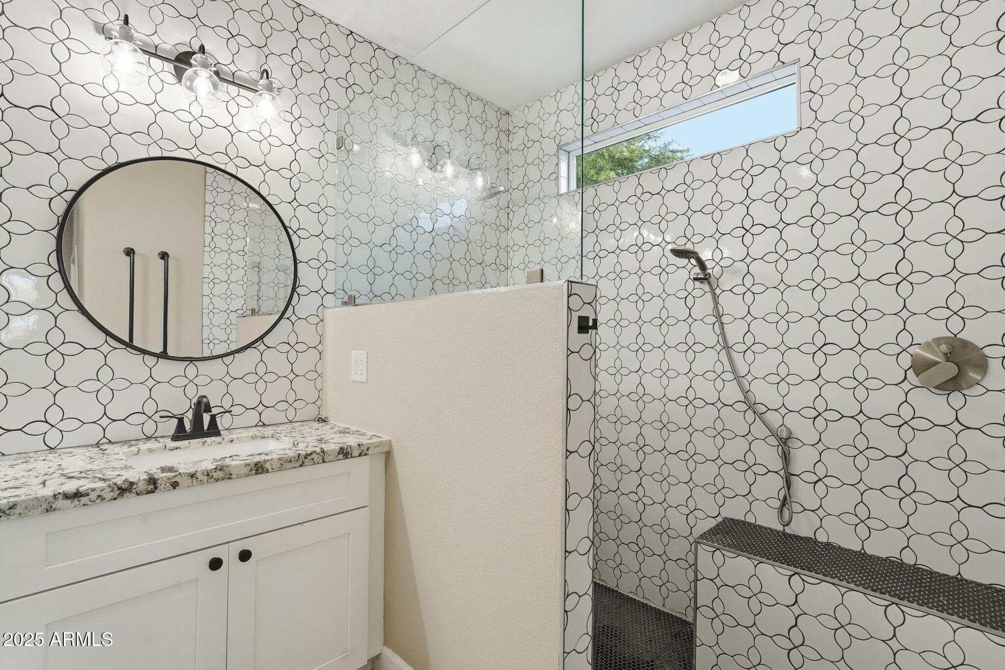 245 West Sagebrush Street Gilbert, AZ 85233 - Photo 27 of 62 a bathroom with a sink a mirror and a shower