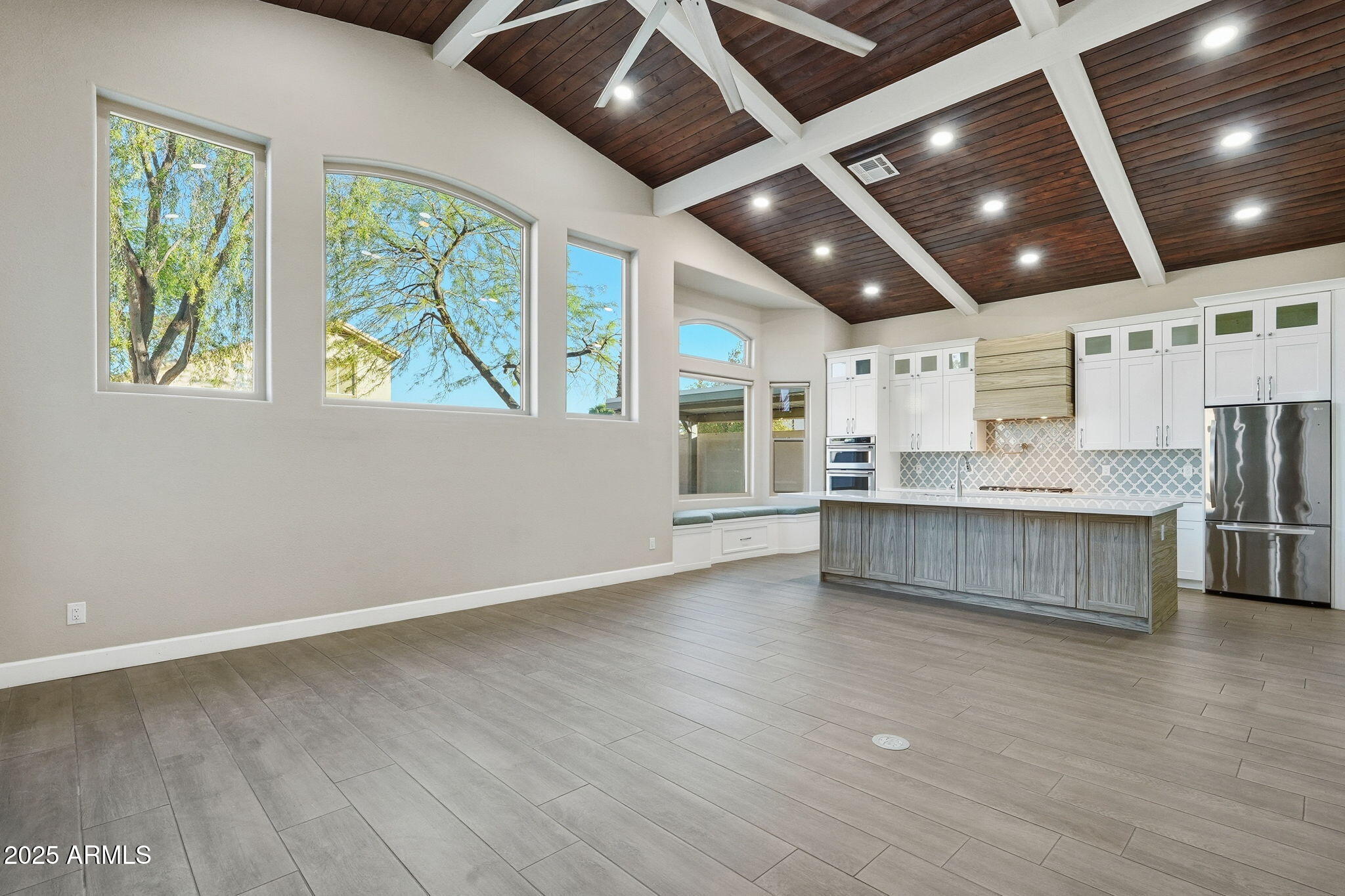 245 West Sagebrush Street Gilbert, AZ 85233 - Photo 7 of 62 a large kitchen with stainless steel appliances granite countertop a large counter top a wooden floors and large window