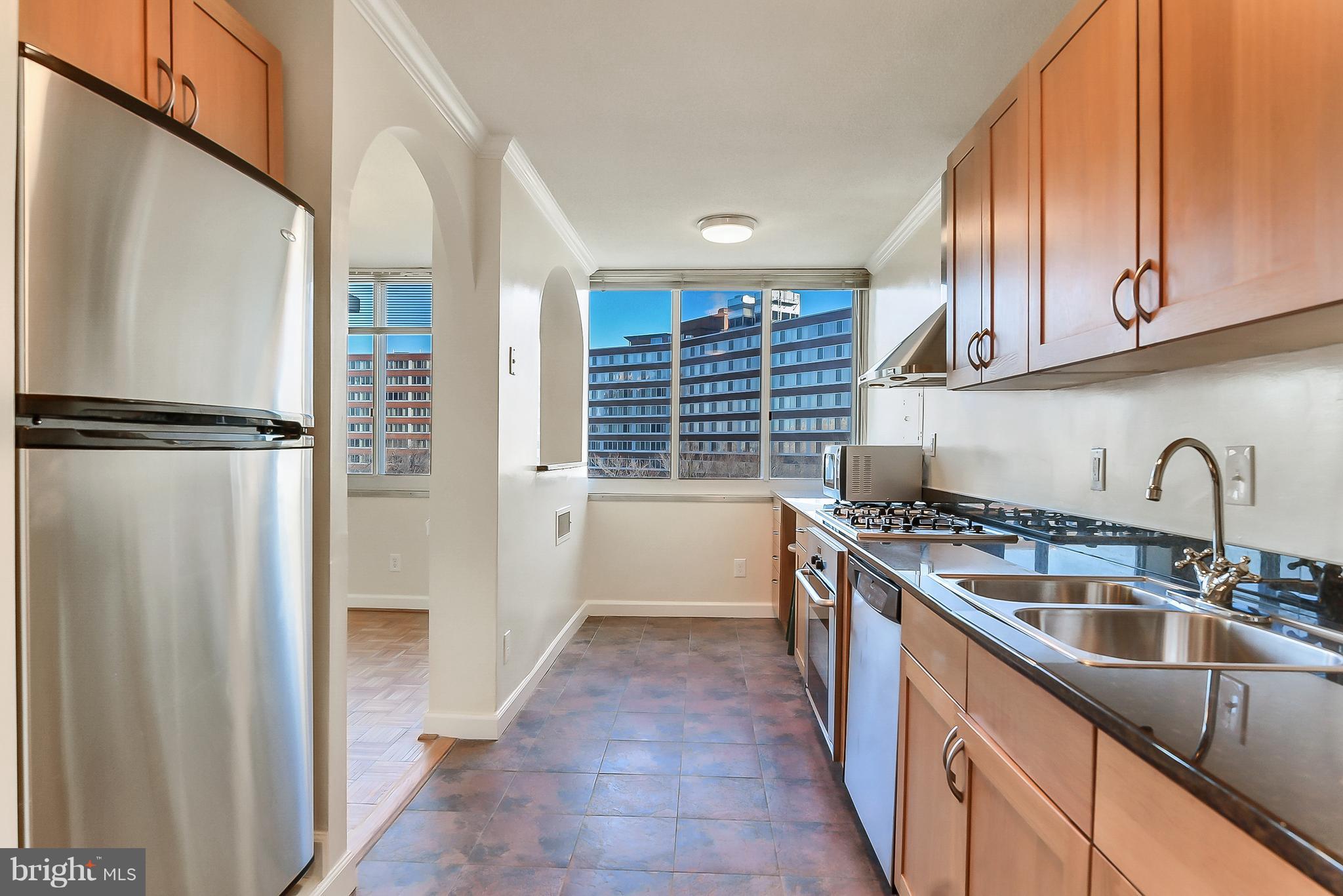 1301 South Arlington Ridge Road, Unit 406 Arlington, VA 22202 - Photo 8 of 27 a kitchen with stainless steel appliances granite countertop a refrigerator and a sink