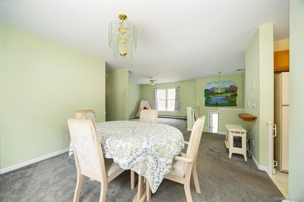 a view of a dining room with furniture and a window