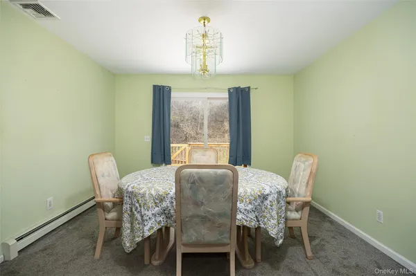 a dining room with furniture and window