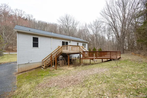 a view of a house with a yard and sitting area