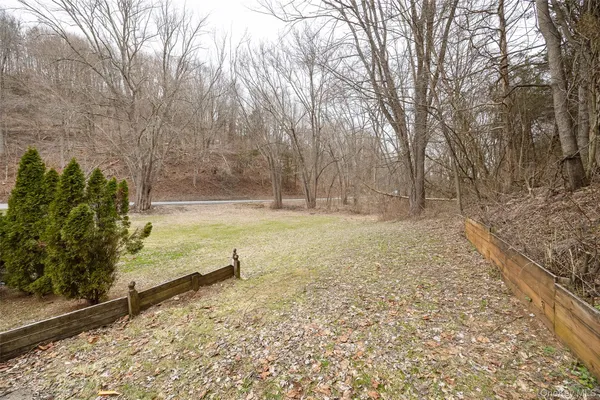 a view of a yard with wooden fence