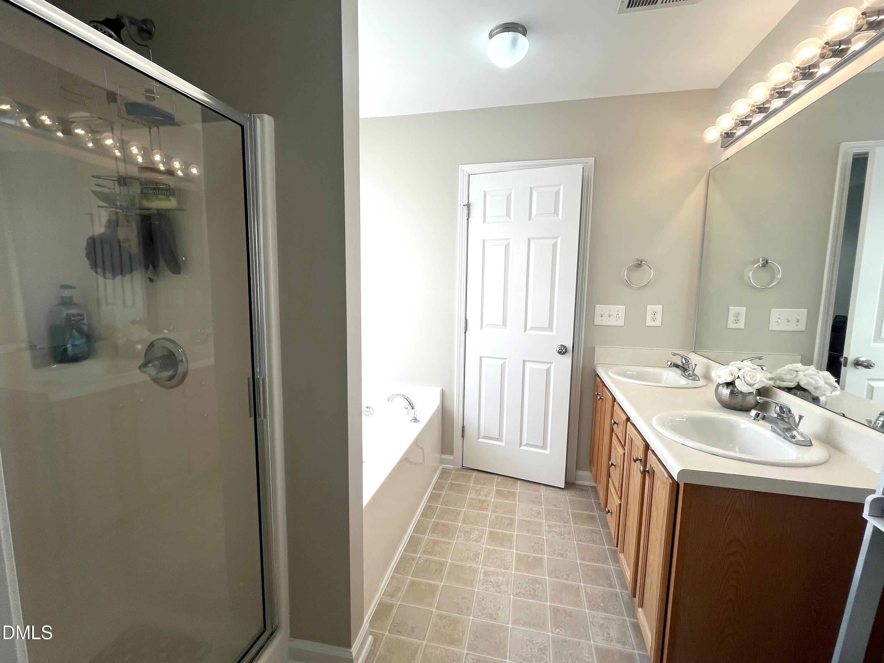 2019 Tennessee Road Durham, NC 27704 - Photo 14 of 21 a en suite bathroom with a sink a mirror and a shower