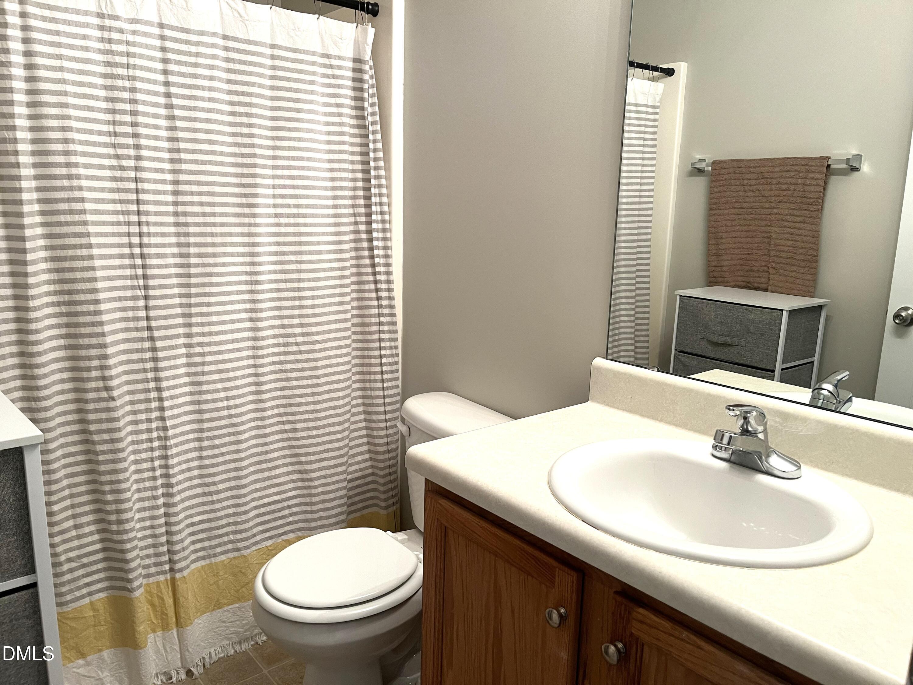2019 Tennessee Road Durham, NC 27704 - Photo 17 of 21 a bathroom with a toilet a sink and mirror