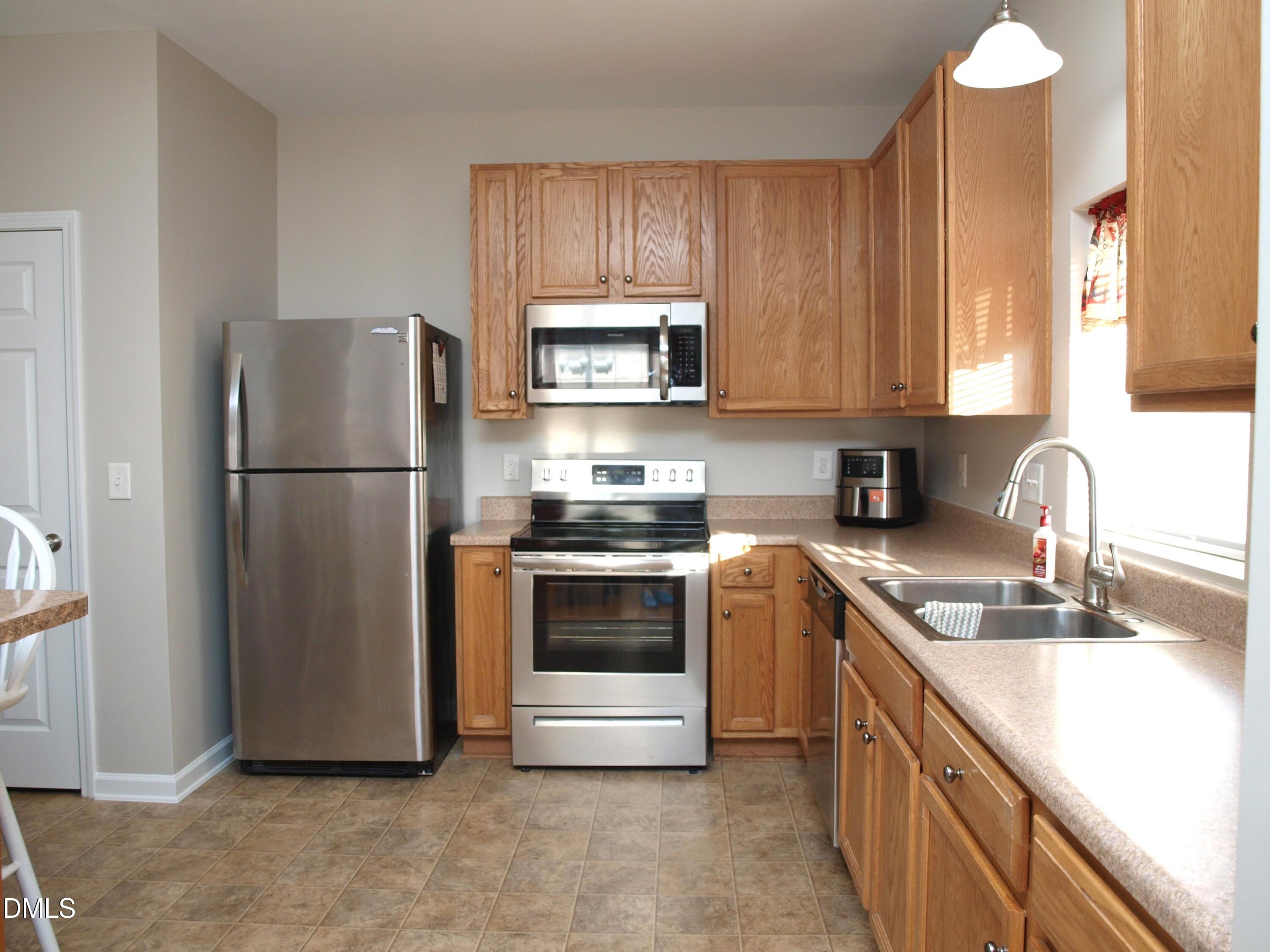 2019 Tennessee Road Durham, NC 27704 - Photo 7 of 21 a kitchen with a refrigerator sink and cabinets