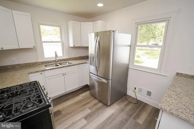 a kitchen with a stove a sink and a refrigerator